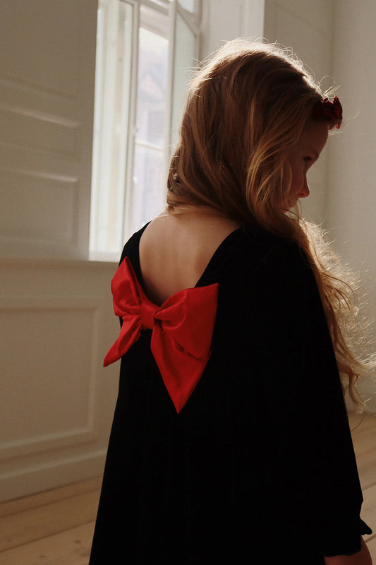 Black Long-Sleeved Dress with Red Bow at Back